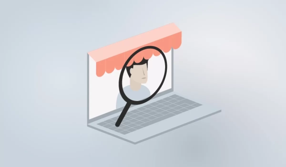 Illustration of a laptop with a storefront awning and a magnifying glass focusing on a person’s face, symbolizing merchant verification and onboarding checks.
